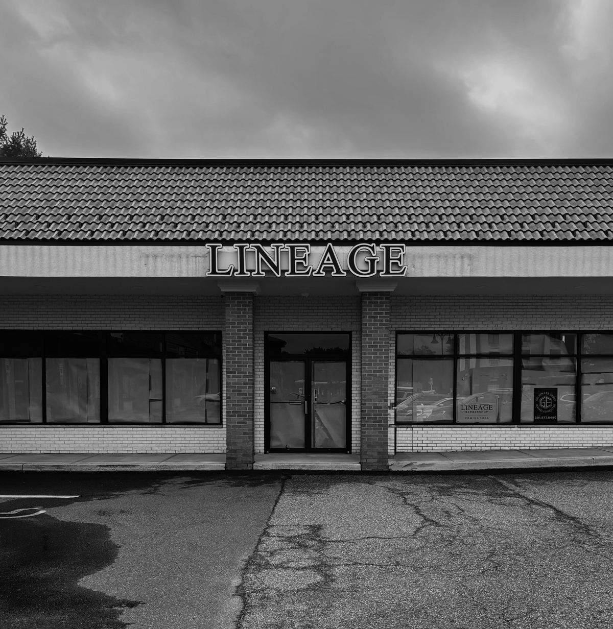 The Lineage Barbershop shopfront on Route 46 in Fairfield, its LINEAGE sign set above the tiled roofline.